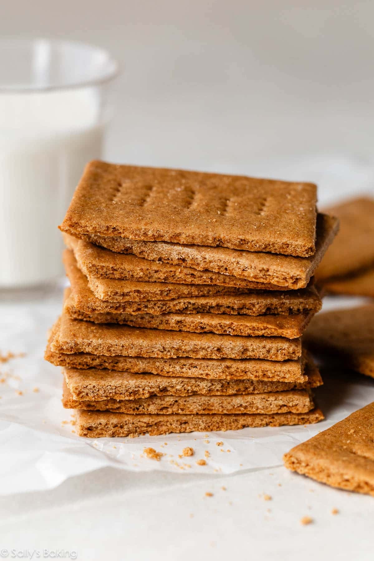 stack of homemade graham crackers with a glass of milk.