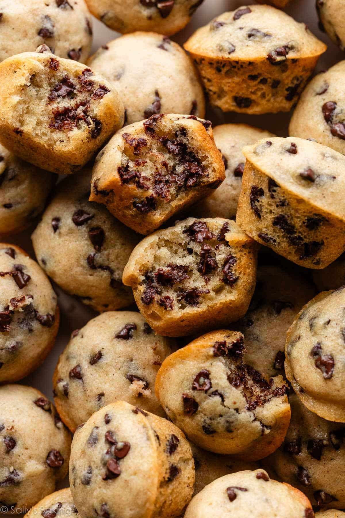 close-up image of mini chocolate chip muffins with bite taken out.