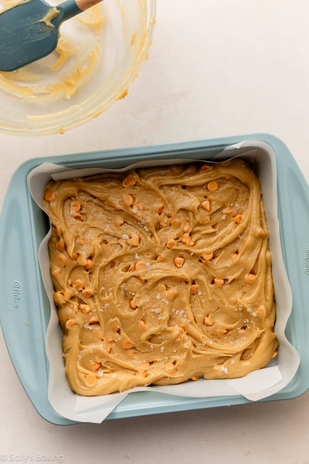 Butterscotch blondie batter in a square baking pan.
