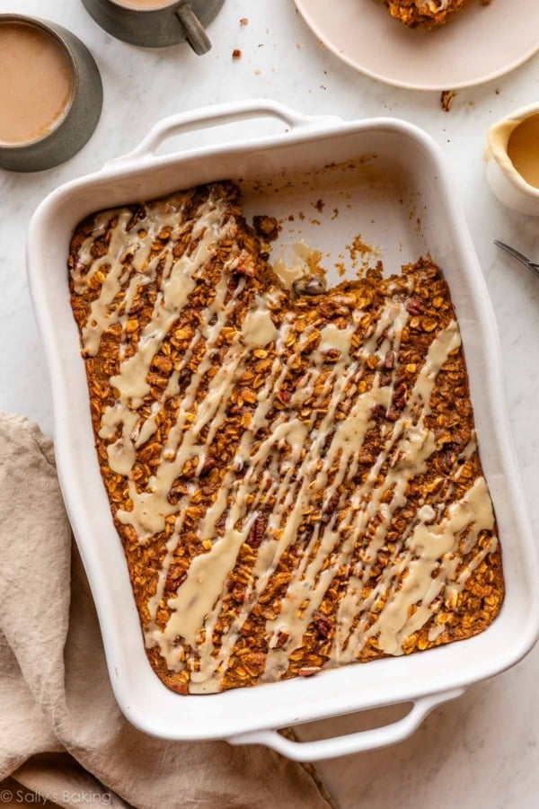 pumpkin baked oatmeal with maple glaze in a white ceramic dish.
