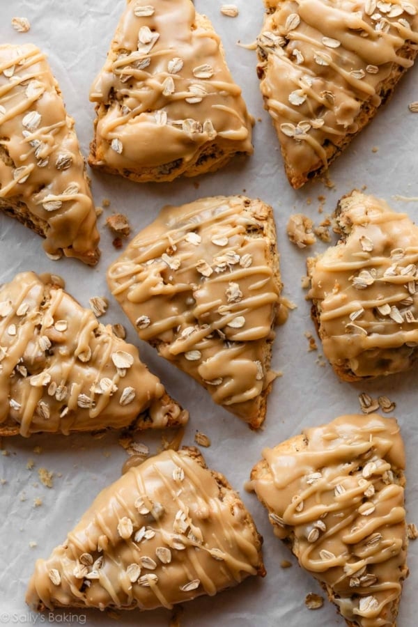 maple oat pecan scones topped with oats and drizzled with icing.