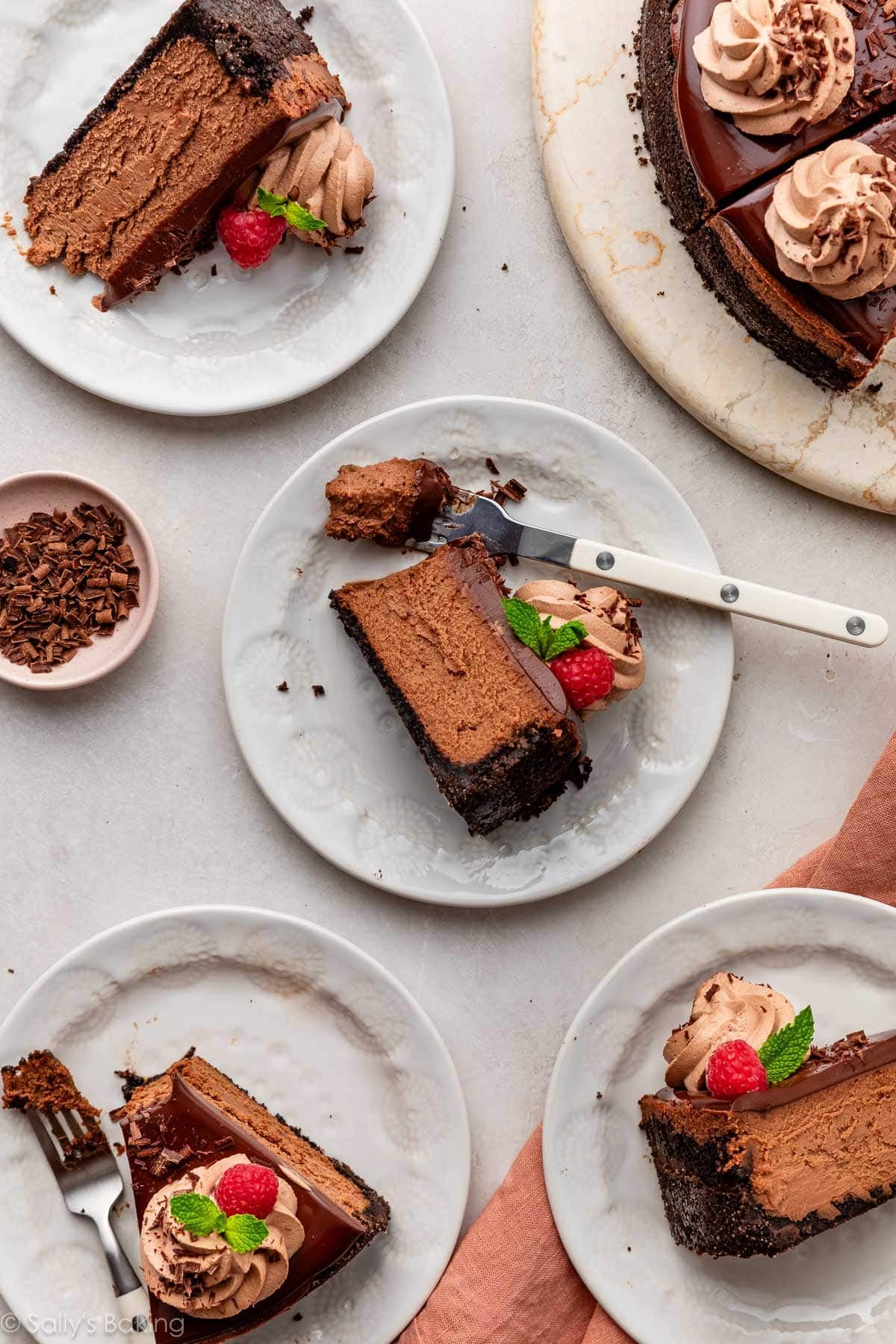 slices of chocolate cheesecake on plates.